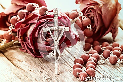 Catholic rosary and dry roses Stock Photo