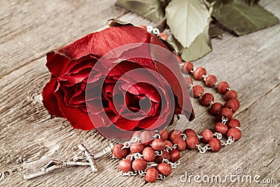 Catholic rosary and red rose Stock Photo