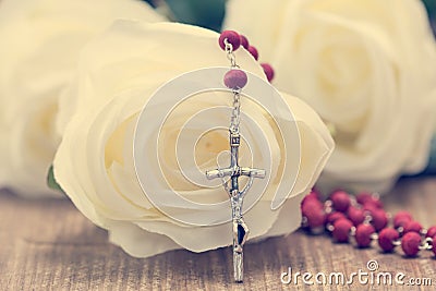 Catholic rosary and white roses Stock Photo