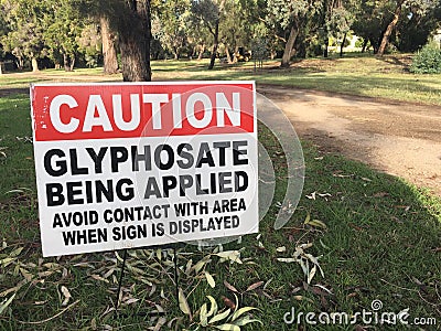 Cation Glyphosate being applied. Outdoor sign on city park path Editorial Stock Photo