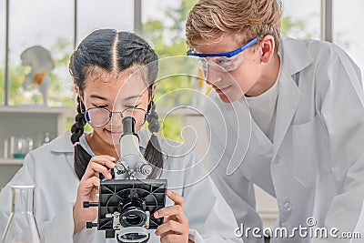 Students using microscope in science laboratory class Stock Photo