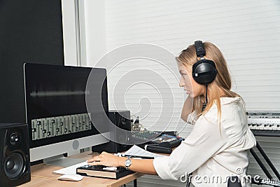 Sound engineer woman headphone editor control audio mixing panel studio recording Stock Photo