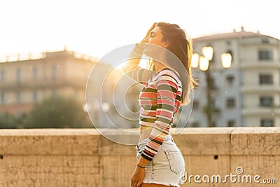 Caucasian beautiful women smiling in city in the sunset Stock Photo