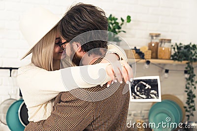 Caucasian blonde woman in white hat hugging her partner with dark hair and beard holding ultrasound photo. Expecting Stock Photo