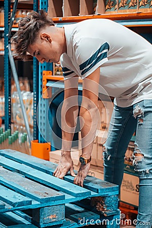 Caucasian Boy in charge in a warehouse reviewing safety regulations Stock Photo