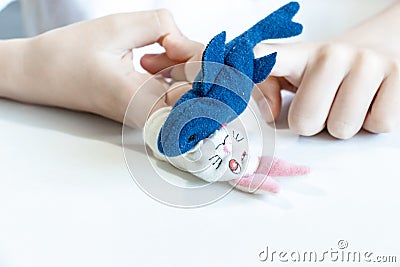 A caucasian boy playing different roles by using finger puppets, toys for expressing his emotions, agression, fear and freandship Stock Photo