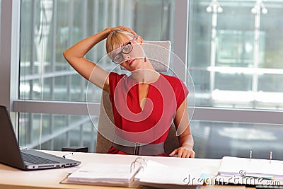 Caucasian business woman in eyeglasses relaxing neck Stock Photo