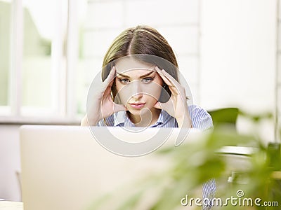 Caucasian business woman thinking in office Stock Photo