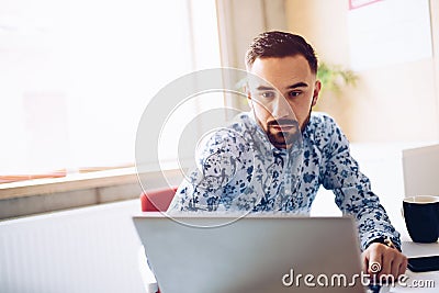 Caucasian concentrated businessman working on laptop computer in his office Stock Photo