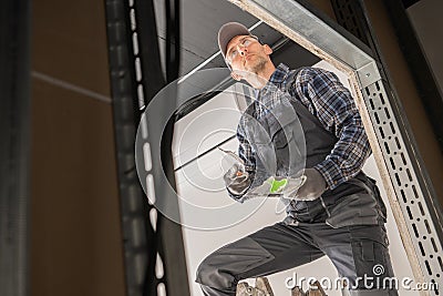 Caucasian Construction Site Worker Patching a Drywall Stock Photo