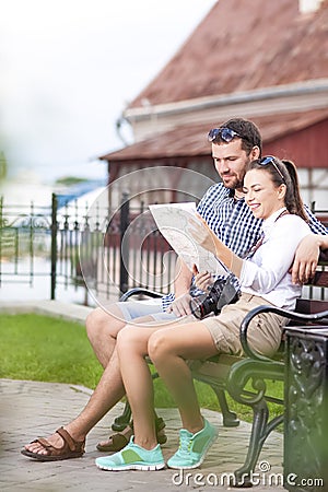 Caucasian Couple Travelling Across the City. Checking Route Using City Map Outdoors. Stock Photo