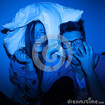 Caucasian couple watching scary movie Stock Photo