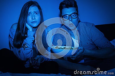 Caucasian couple watching scary movie Stock Photo