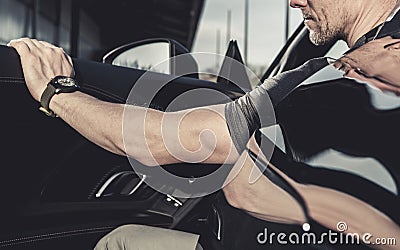 Caucasian Driver Leaving His Supercar Close Up Stock Photo