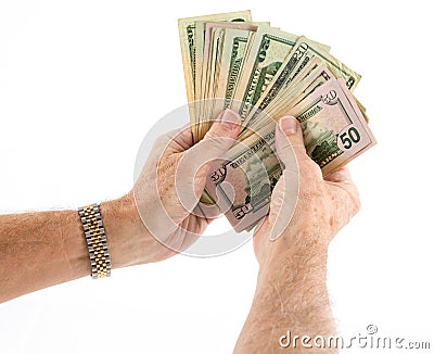 Caucasian ethnicity hands holding fan of US dollar bills Stock Photo