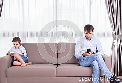 Caucasian family in status of serious. Father and son sitting on Stock Photo