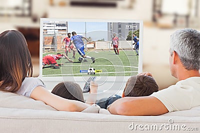 Caucasian family watching tv with football match on screen Stock Photo