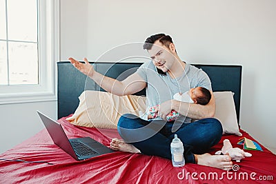 Caucasian father dad with newborn mixed race Asian Chinese baby working from home Stock Photo