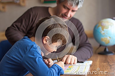 Caucasian father and son doing mathematics homework Stock Photo