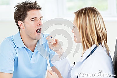 Caucasian female doctor taking a saliva sample Stock Photo