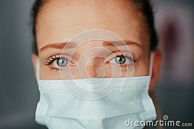 Caucasian female nurse trainee standing in doctors office wearing mask Stock Photo