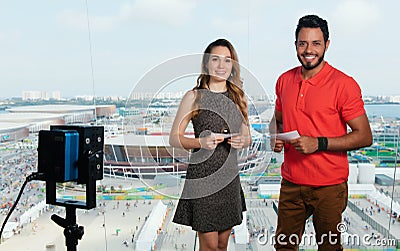 Caucasian female presenter and latin man at tv studio Stock Photo