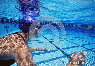 Caucasian female swimmers swimming in pool Stock Photo