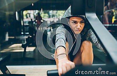 Caucasian fit brunette woman is doing exercises for legs in the gym, sporty woman exercising with barbell in the gym. Fitness, Stock Photo