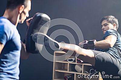 Caucasian Fitness instructor teach and motivate young sportsman boxer exercise doing boxing or Muay Thai. Athlete fighter in Stock Photo