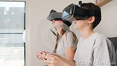 Girl and her young brother playing driving simulation video games Stock Photo
