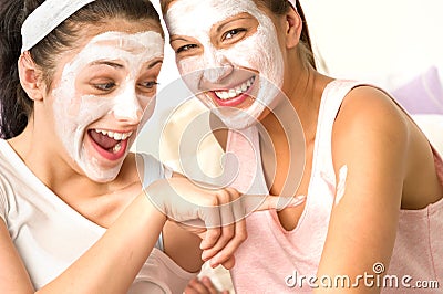 Caucasian girls wearing peeling mask having fun Stock Photo