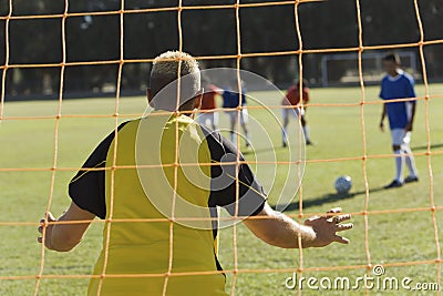 Caucasian Goalkeeper Ready To Save A Shot Stock Photo