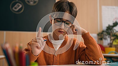 Caucasian guy boy think find idea ponder difficult task writing notes math exercise class lesson school learn write Stock Photo