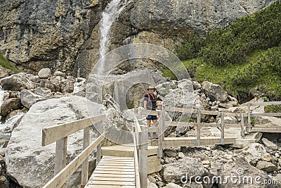 Caucasian hiker on the Drischlsteig towards Muttekopfhütte mountain hut during summer in Imst, Tirol. Stock Photo