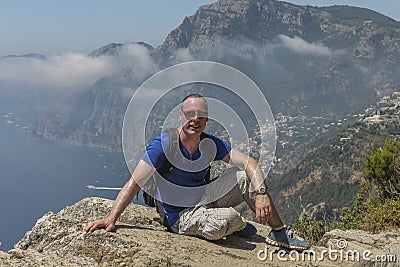 Caucasian hiker posing on the Sentiero degli dei trail ( path of the Gods) on the Amalfi coast. Stock Photo