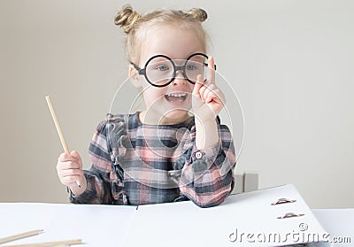 Caucasian little girl with round glasses. Little teacher Stock Photo