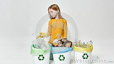 Little girl sorting plastic bottle in variety bins Stock Photo