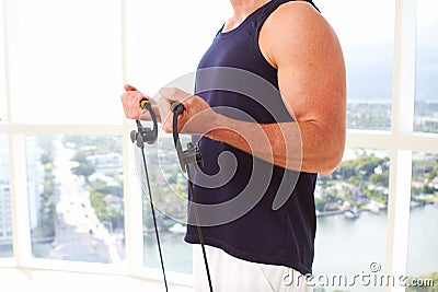 Caucasian male doing resistance training indoors Stock Photo