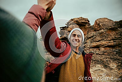 Caucasian male hiker high five female after pitching tent on top of mountain Stock Photo