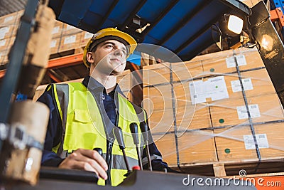 Caucasian male worker working in warehouse goods store. inventory staff moving producs pallet shipping management with folk lift Stock Photo