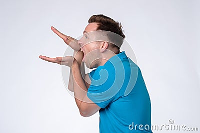 Caucasian man in blue shirt making bla bla sign with his hand Stock Photo