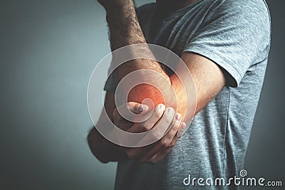 Caucasian man with elbow pain. Pain relief concept Stock Photo