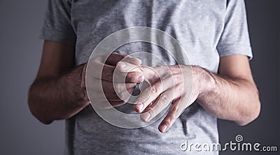 Caucasian man with finger ache. Arthritis, wrist pain Stock Photo