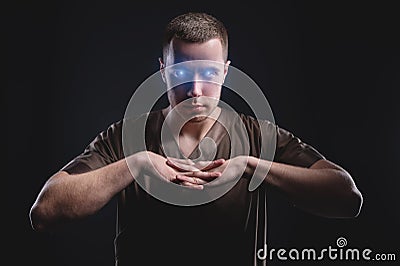 Caucasian man with glowing eyes reads your mind. Makes you suggestion and telekinesis Stock Photo