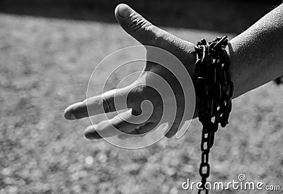 Caucasian man hand in rusty chains , shallow depth of field, conceptual image of crime,slavery Stock Photo