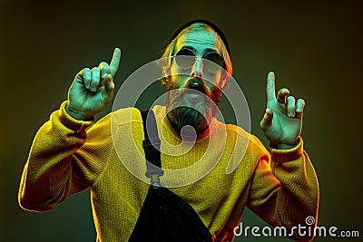 Caucasian man`s portrait isolated on gradient studio background in neon light Stock Photo