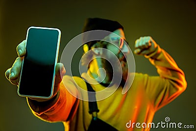 Caucasian man`s portrait isolated on gradient studio background in neon light Stock Photo