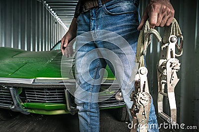 A Man with a Straps Next to Shipped Classic Car Stock Photo