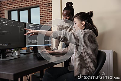 Caucasian network developer pointing out high usage of processing power in mainframe grid. Stock Photo