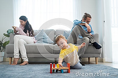 Caucasian phone addict parents don`t pay attention with baby toddler. Family problem, Father and Mother sit on sofa and using Stock Photo